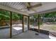 Covered patio area with ceiling fan, perfect for outdoor dining or relaxation, overlooking the fenced backyard at 5105 Parrum Ct, Summerville, SC 29485