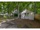 Backyard storage shed offers ample storage space amidst mature trees and shaded areas at 5105 Parrum Ct, Summerville, SC 29485