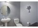 Charming bathroom with stylish pedestal sink and South Carolina themed artwork on the gray painted walls at 5134 E Liberty Park Cir, North Charleston, SC 29405