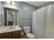 Functional bathroom featuring a vanity, toilet, and shower with a white curtain providing privacy at 5134 E Liberty Park Cir, North Charleston, SC 29405