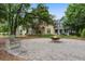 Community area with a fire pit, swing, benches, and well-maintained landscaping between yellow and green homes at 5134 E Liberty Park Cir, North Charleston, SC 29405