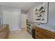 Hallway with a view of a bedroom, featuring a closet, storage units, and a decorative map at 5134 E Liberty Park Cir, North Charleston, SC 29405