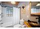 Stylish bathroom featuring wood-look sink, white shower, and accent walls at 520 E Huron Ave, Folly Beach, SC 29439