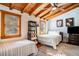 Cozy bedroom with wood-beam ceiling, two beds, and large windows allowing for ample natural light at 520 E Huron Ave, Folly Beach, SC 29439