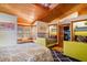 Inviting bedroom with wood-beam ceilings, large windows, seating and ensuite bathroom at 520 E Huron Ave, Folly Beach, SC 29439