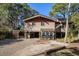 Charming home exterior featuring a spacious driveway, a carport and mature trees enhancing the curb appeal at 520 E Huron Ave, Folly Beach, SC 29439