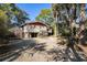 Charming home exterior featuring a spacious driveway, a carport and mature trees enhancing the curb appeal at 520 E Huron Ave, Folly Beach, SC 29439