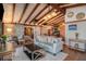 Inviting living room features exposed beam ceilings, sliding barn doors, and comfortable seating at 520 E Huron Ave, Folly Beach, SC 29439