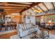 Spacious living room with exposed beam ceiling, wood floors and comfortable seating at 520 E Huron Ave, Folly Beach, SC 29439