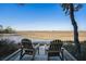 Tranquil marsh view with seating, showcasing the natural beauty of the surrounding landscape at 520 E Huron Ave, Folly Beach, SC 29439