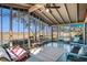 Inviting screened-in porch featuring multiple seating areas and pleasant views of the surrounding natural landscape at 520 E Huron Ave, Folly Beach, SC 29439