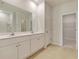 Neutral bathroom featuring double sink vanity, tiled floors, and entrance to a closet at 528 Blue Mistflower Dr, Moncks Corner, SC 29461