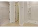 Bright, clean bathroom with tiled floors, walk-in shower and entrance to a closet at 528 Blue Mistflower Dr, Moncks Corner, SC 29461