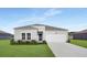 Charming single-story home with gray siding, a well-manicured lawn, and an attached two-car garage at 528 Blue Mistflower Dr, Moncks Corner, SC 29461