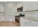 Modern kitchen with white cabinets, stainless steel appliances, and stylish tile backsplash at 528 Blue Mistflower Dr, Moncks Corner, SC 29461