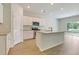 Elegant kitchen with stainless appliances, granite countertops, white cabinets, and hardwood floors at 528 Blue Mistflower Dr, Moncks Corner, SC 29461