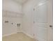 Bright laundry room with tile flooring and a convenient wire shelf for storage at 528 Blue Mistflower Dr, Moncks Corner, SC 29461