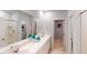 Bright bathroom featuring double sinks, a large mirror, and a separate shower at 529 Blue Mistflower Dr, Moncks Corner, SC 29461