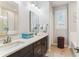 Bright bathroom features a double sink vanity, large mirror, and tiled flooring at 542 Amalie Farms Dr, Charleston, SC 29492