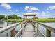 Wooden dock leading to a river with a gazebo and views of surrounding marshlands at 542 Amalie Farms Dr, Charleston, SC 29492