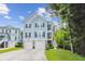 Charming two-story home with a two-car garage, blue siding, and a well-manicured lawn at 542 Amalie Farms Dr, Charleston, SC 29492