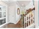 Elegant hallway with hardwood floors, white trim, and a staircase leading upstairs at 542 Amalie Farms Dr, Charleston, SC 29492