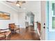 Bright hallway with hardwood floors, chair railing, coastal decor, and staircase to the lower level at 542 Amalie Farms Dr, Charleston, SC 29492