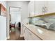 Hallway with a counter, white cabinets and drawers, and a view of a desk in the distance at 542 Amalie Farms Dr, Charleston, SC 29492