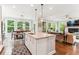 Modern kitchen with a center island, stainless steel appliances, and hardwood floors at 542 Amalie Farms Dr, Charleston, SC 29492