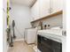 Convenient laundry room equipped with a washer, dryer, and ample storage space at 542 Amalie Farms Dr, Charleston, SC 29492