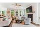 Cozy living room with a fireplace, shiplap accent wall, and hardwood floors at 542 Amalie Farms Dr, Charleston, SC 29492