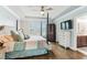 Main bedroom with a four poster bed, hardwood floors, and an ensuite bathroom at 542 Amalie Farms Dr, Charleston, SC 29492