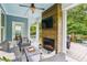 Cozy screened porch with comfortable seating, a fireplace, and access to an outdoor deck at 542 Amalie Farms Dr, Charleston, SC 29492