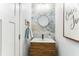 Stylish powder room features unique mirror, vanity and wall tile at 542 Amalie Farms Dr, Charleston, SC 29492