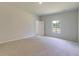 Bright bedroom has neutral walls and carpet and a window with a view of the yard at 549 Blue Mistflower Dr, Moncks Corner, SC 29461
