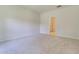 A bright bedroom features neutral carpet and walls and an open doorway to another room at 549 Blue Mistflower Dr, Moncks Corner, SC 29461
