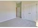 Neutral bedroom with carpet, closet with double doors, and doorway to another room at 549 Blue Mistflower Dr, Moncks Corner, SC 29461
