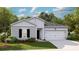 Inviting single-story home with a gray facade, two-car garage, and landscaped front yard at 549 Blue Mistflower Dr, Moncks Corner, SC 29461