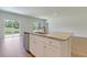 Granite kitchen island with a stainless dishwasher and sink in a new construction home at 549 Blue Mistflower Dr, Moncks Corner, SC 29461