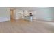 Spacious open-concept area with wood floors, seamlessly connecting living, dining, and kitchen spaces at 549 Blue Mistflower Dr, Moncks Corner, SC 29461