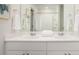 Bathroom featuring double sinks, framed mirror, and white cabinets with chrome fixtures at 551 Blue Mistflower Dr, Moncks Corner, SC 29461
