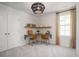 Bright bedroom featuring a unique light fixture, built-in desk with shelving, and a window at 551 Blue Mistflower Dr, Moncks Corner, SC 29461