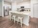 Modern kitchen featuring white cabinets, stainless steel appliances, granite countertops, and a convenient breakfast bar at 551 Blue Mistflower Dr, Moncks Corner, SC 29461