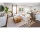 Stylish living room showcasing a plush white sofa, a unique wood coffee table, and large windows for ample natural light at 551 Blue Mistflower Dr, Moncks Corner, SC 29461