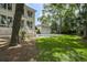 Charming backyard featuring a detached garage, lush lawn, and mature trees providing ample shade at 578 Island Walk East, Mount Pleasant, SC 29464