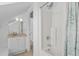 Bright bathroom featuring a shower with decorative curtain, a granite vanity, and neutral-toned tile flooring at 578 Island Walk East, Mount Pleasant, SC 29464