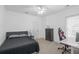 This bedroom features a bed, ceiling fan, chest of drawers, and a desk with a gaming chair at 578 Island Walk East, Mount Pleasant, SC 29464
