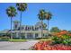 Community clubhouse with palm trees and landscaped flower beds at 578 Island Walk East, Mount Pleasant, SC 29464