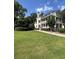 Stately multi-story home with a well-manicured lawn, covered porches, and lush landscaping at 578 Island Walk East, Mount Pleasant, SC 29464