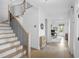 Hallway with wooden floors and staircase leads to a naturally lit, open office at 578 Island Walk East, Mount Pleasant, SC 29464